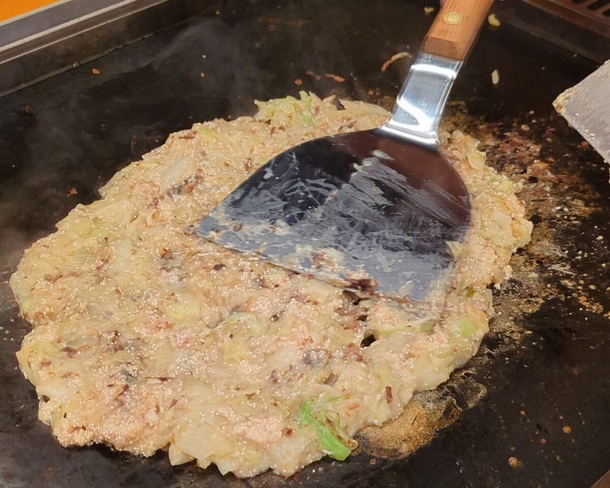 月島もんじゃたまとや綱島の明太もちもんじゃ焼いているところ